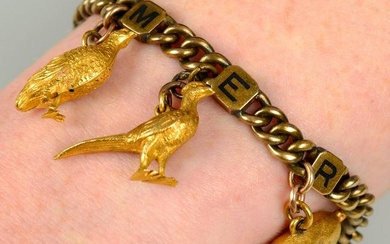 An early 20th century 18ct gold curb-link bracelet, with three enamel initial panel spacers reading