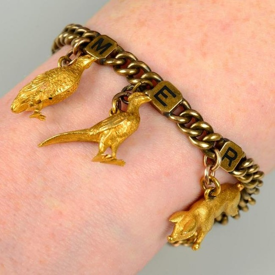 An early 20th century 18ct gold curb-link bracelet, with three enamel initial panel spacers reading