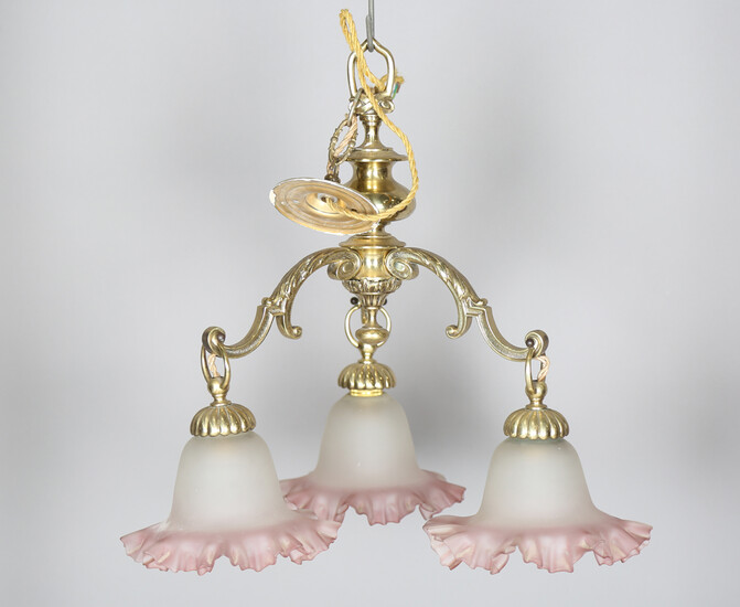 An early 20th century gilt brass three-branch chandelier with opaque frilled glass shades, height 46