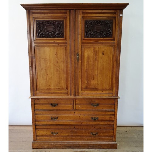 An early 20th century walnut linen press, with two doors, to...