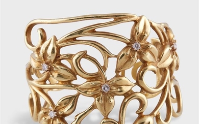 An eighteen karat gold and diamond cuff bracelet with...