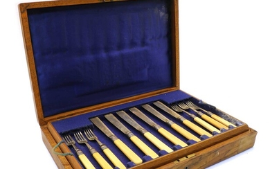 An oak cased set of eight fish knives and forks