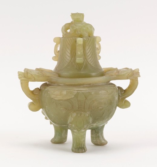 CHINESE GREEN JADE-LIKE HARDSTONE COVERED KORO Carved body with two mask-head handles and three mask-head feet. Cover with open-carv...