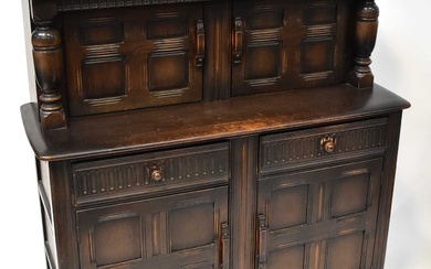ERCOL; a dark stained elm court cupboard, 127 x 121.5...