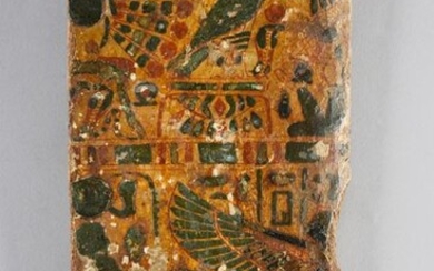 Fragment of the lid of a sarcophagus decorated with a Horus, a beetle and wings of the goddess Isis. Stuccoed wood and pigments.
