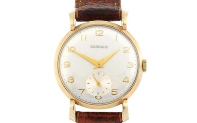 GARRARD - a 9ct yellow gold wrist watch, 33mm.