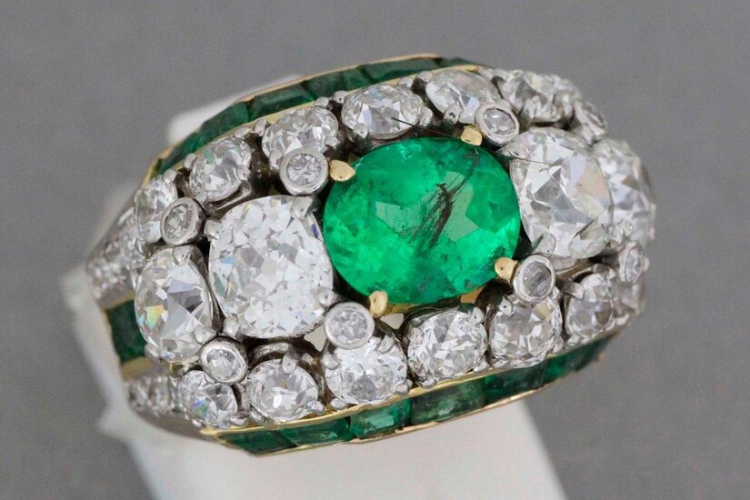 Gold and platinum ring set with an emerald set with...