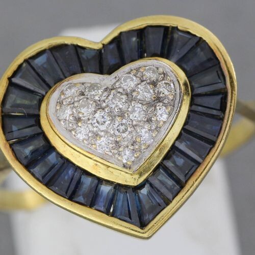Gold "heart" ring set with a pavé of brilliants in...