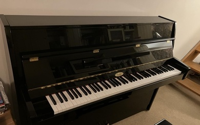 Kemble (c2013) A modern upright piano in a bright ebonised c...