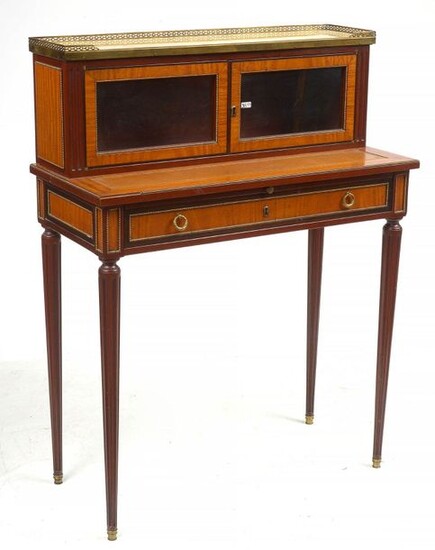 Small Louis XVI style lady's writing desk in curly mahogany veneer with a magnifying glass door opening by two glass doors in the upper part and fitted with a drawer in the belt. Gilded bronze gallery and ornamentation. Yellow marble shelf. Period:...