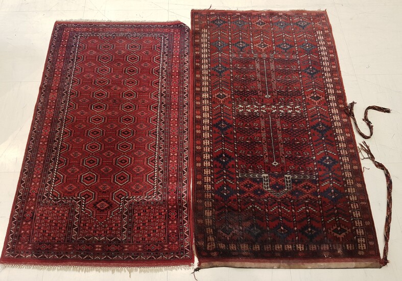 TWO RUGS hand-knotted with geometrical forms, dominant red, one long....