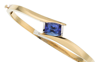 Tanzanite, Gold Bracelet The hinged bangle features a cushion-shaped...