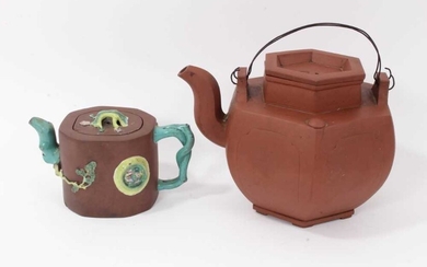Two Chinese Yixing teapots, 19th/20th century, the first of hexagonal form, seal marks to cover and base, 16cm high, the other with branch form handle and spout, enamelled in relief, 10cm high