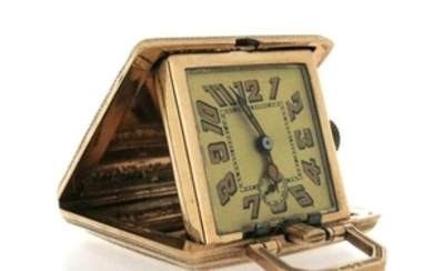 A 9ct gold travel clock, the square shaped case wi…