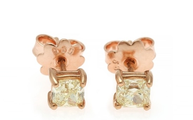 A pair of diamond solitaire ear studs each set with a cushion-cut diamond totalling app. 0.90 ct., mounted in 14k rose gold. (2)