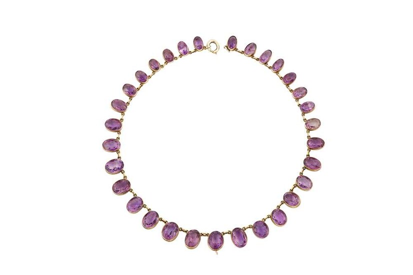 An amethyst rivière The graduated strand of oval-cut amethysts,...