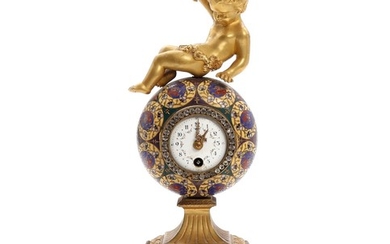 A French cloisonné and bronze mantel clock, surmounted by putto holding a grapewine. C. 1900. H. 27.5 cm.