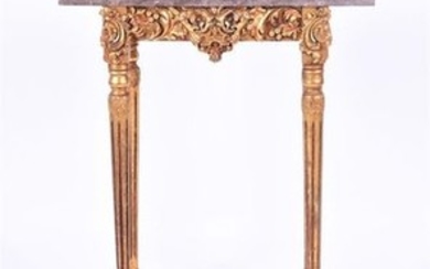 An Italian carved giltwood and marble top side table the base with extensive scroll work and rocaille motif, supported on...