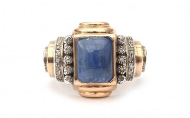 A 14 karat rose gold and silver cocktail ring, ca. 1940. Featuring a cabochon cut sapphire flanked by ten small rose cut diamonds. A geometrically designed shank elaborated with engraved shoulders. Gross weight: 8.55 g.