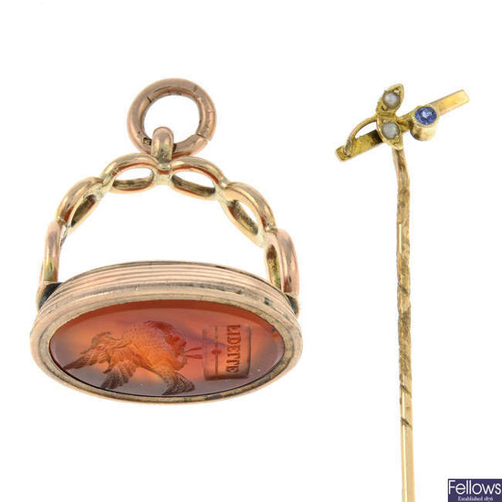 A 19th century gold carnelian fob seal and an early 20th century 9ct gold sapphire and split pearl stickpin.