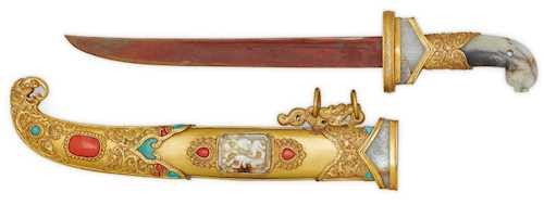 A CEREMONIAL DAGGER SET WITH JADE CARVINGS, CORALS AND TURQUOISES.