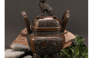 A Chinese bronze censer and cover, surmounted by a temple li...