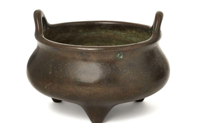 A Chinese bronze two-handled tripod censer, 18th/19th century, of typical bombe form, the base cast with an apocryphal four-character Xuande mark in relief, 16cm diameter