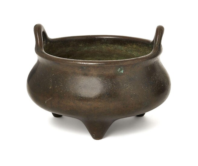 A Chinese bronze two-handled tripod censer, 18th/19th century, of typical bombe form, the base cast with an apocryphal four-character Xuande mark in relief, 16cm diameter