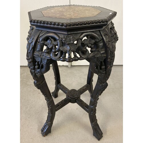 A Chinese carved hardwood octagonal topped plant stand. Carv...