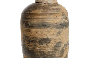 A Chinese earthenware model of granary Han dynasty The brownish grey cylindrical...