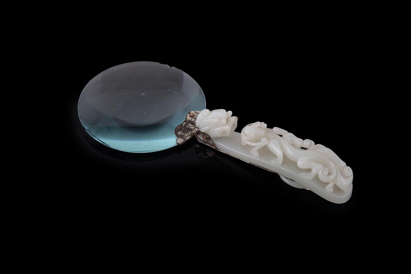A Chinese pale celadon jade belt hook adapted as a magnifying glass