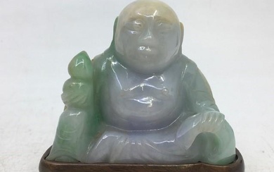 A Chinese pale green carved jade figure depicting buddha