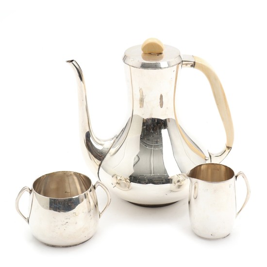 A. F. Rasmussen: A three-piece sterling silver coffee set comprising coffee pot with ivory handle and finial, and sugar bowl and creamer. H. 6.5–21 cm. (3)