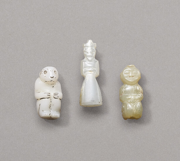A GROUP OF THREE JADE CARVINGS, WHITE JADE HUMAN-FORM PENDANT (MIDDLE): WESTERN ZHOU DYNASTY (1100-771 BC) TWO SMALL JADE FIGURAL CARVINGS: WESTERN ZHOU DYNASTY OR LATER
