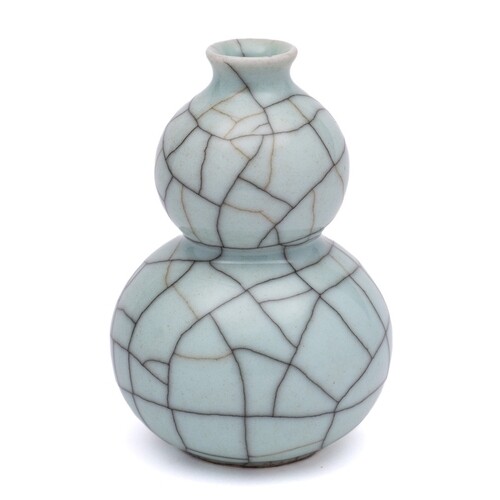 A Guan type vase: of double gourd form under crazed celadon ...