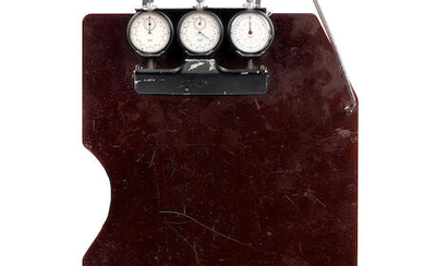A Heuer laptime keeper's clipboard fitted with three Heuer stopwatches