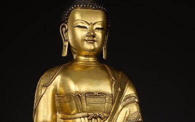 A LARGE GILT-BRONZE FIGURE OF BUDDHA SHAKYAMUNI, KANGXI TO YONGZHENG PERIOD