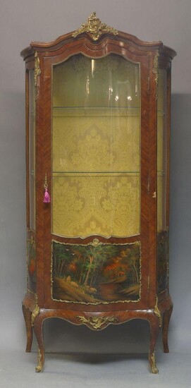 A Louis XV style Kingwood and gilt metal mounted Vernis Martin vitrine, early 20th Century, the curved glazed door enclosing two shelves, over panels painted with woodland scenes, on square cut curvilinear legs, 173cm high, 83cm wide, 44cm wide