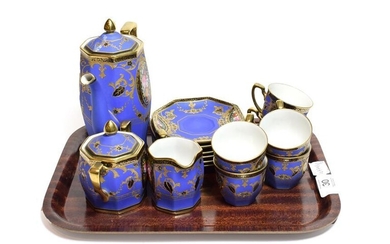 A Noritake coffee set, the matte blue ground with panels...