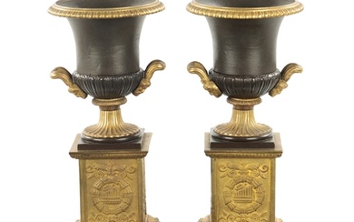 A PAIR OF 19TH CENTURY BRONZED GILT CAST IRON URNS of classi...