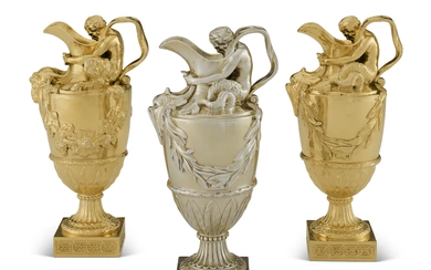 A PAIR OF EDWARDIAN SILVER-GILT EWERS AND MATCHING GEORGE V EWER MARK OF EDWARD BARNARD & SONS, LONDON, 1905, 1910