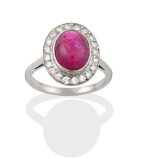 A Ruby and Diamond Cluster Ring, the cabochon ruby in...