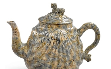 A STAFFORDSHIRE SOLID-AGATE PECTEN-SHELL TEAPOT AND COVER, CIRCA 1750