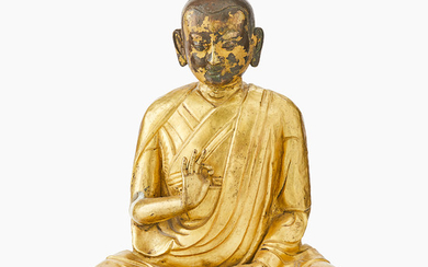 A Tibetan gilt copper figure of a Luohan
