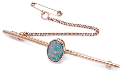 A VINTAGE 9CT ROSE GOLD OPAL BAR BROOCH; centring a rub set opal doublet (chipped around edges, between tapered upswept shoulders, s...