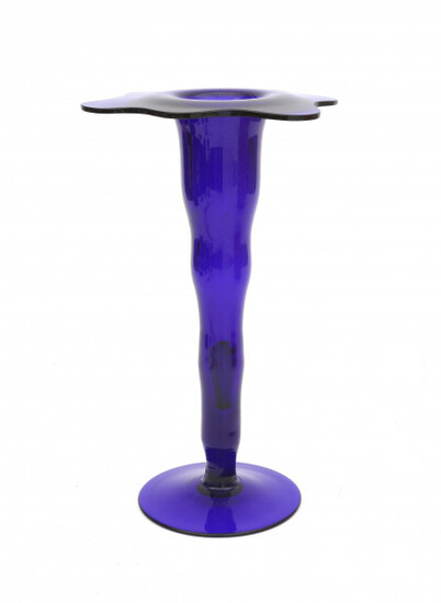 A blue glass vase of wavy design, both for the body as well as the top rim, unsigned.