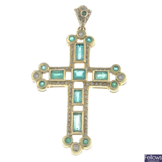 A brilliant-cut diamond and emerald cross pendant.
