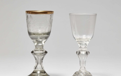 A cut glass goblet with two coats-of-arms