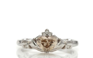 A diamond ring set with a heart-shaped brilliant-cut natural brown diamond weighing...