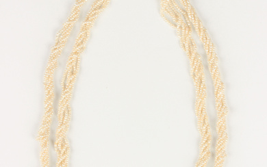A graduated multiple row seed pearl necklace, the front spaced with two emerald beads and two large